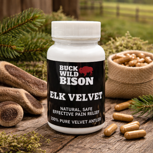 Buck Wild Bison Elk Velvet supplement bottle on a wooden surface with natural elements.