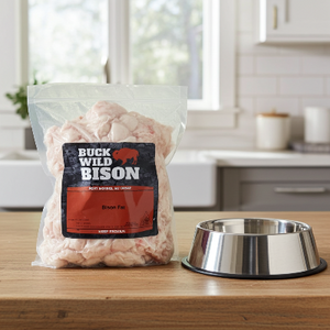 Bag of bison suet on a kitchen counter with a metal dog bowl.